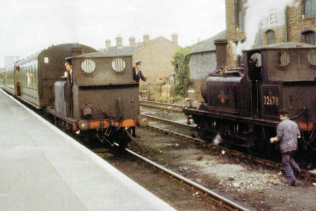 An arrival at Havant from Hayling Island in which the fireman is acknowledging the driver of 32678.