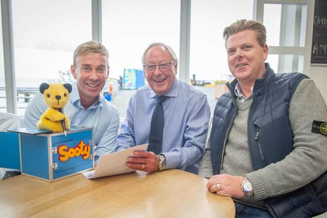 13/11/19  Richard Cadell, who owns the rides on South Parade Pier is signing another 15-year lease.Pictured: Richard Cadell with Sooti signing the lease with David Deacon and Tommy Ware.Picture: Habibur Rahman