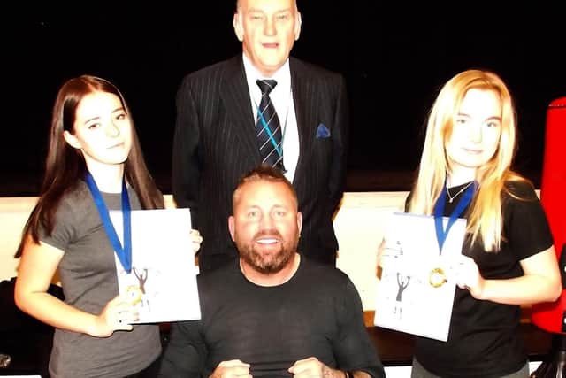 Ava Cochrane and Ellie Sherlock, who this week received award certificates, pictured with club mentor Knox White and Bob Hind