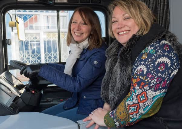 Joanne Vines and Sammy Ellen at the wheel of the bus. Picture: Keith Woodland