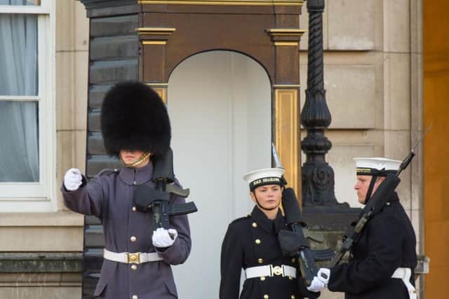 Able seaman Alex Stacey (centre) takes her position in a sentry box, as sailors from the Royal Navy perform the Changing of the Guard ceremony at Buckingham Palace, London, for the first time in its 357-year history. Picture: Dominic Lipinski/PA