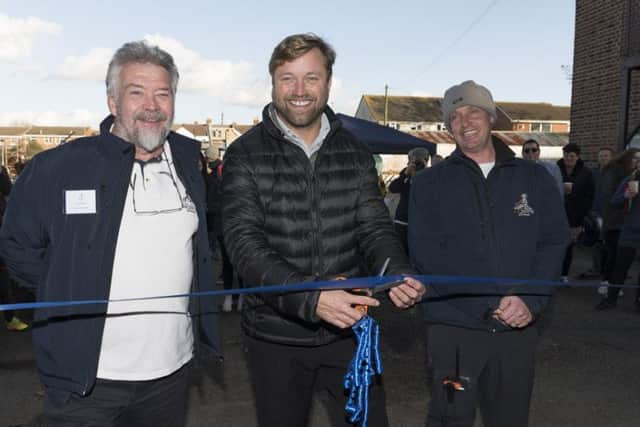 Alex Thomson cuts the ribbon