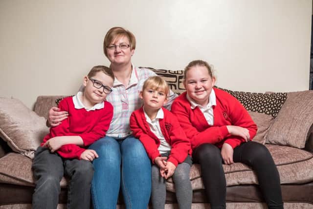 Charlie Harri with mum Marie and sisters Millie and Sofie at their Hilsea home Picture: Mike Cooter