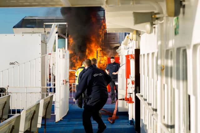Crew of the Wightlink ferry, St Faith, rush to extinguish the fire
Picture: Christopher Ison