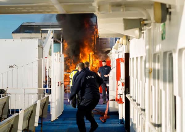 Crew of the Wightlink ferry, St Faith, rush to extinguish the fire 
Picture: Christopher Ison