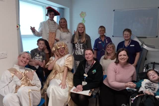 Cast members of Starlight Children's Foundation pantomime with children from the ward