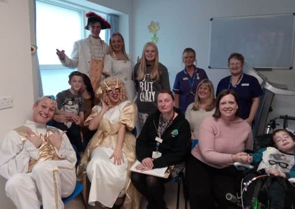 Cast members of Starlight Children's Foundation pantomime with children from the ward