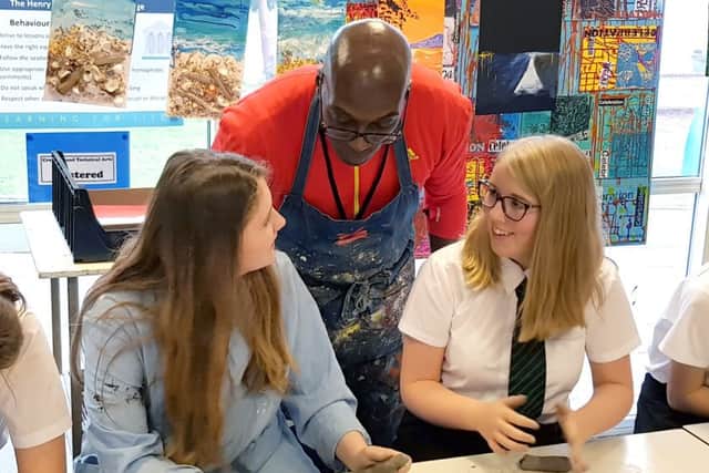 Sculptor Donald Brown runs a class for Henry Cort students
