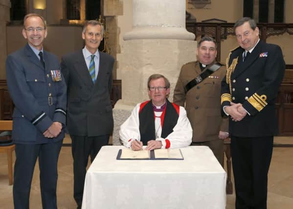 From left: Air Commodore Alan Opie from the Royal Air Force; Lord-Lieutenant of Hampshire Nigel Atkinson; Anglican Bishop of Portsmouth the Rev Christopher Foster; The Rev Ian Stevenson and Second Sea Lord Vice Admiral Jonathan Woodcock signing the Armed Forces Covenant  at Portsmouth Anglican Cathedral   
Picture: Habibur Rahman