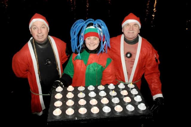 Volunteers Dan Greasley, Claire Desty and Percy Phelps at last year's Lake of Lights Service
