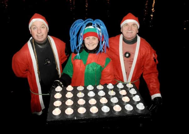 Volunteers Dan Greasley, Claire Desty and Percy Phelps at last year's Lake of Lights Service