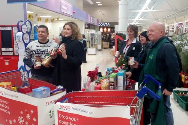 Portsmouth North MP Penny Mordaunt, second from left, poses with Tesco staff and Portsmouth Foodbank volunteers. Picture: David George