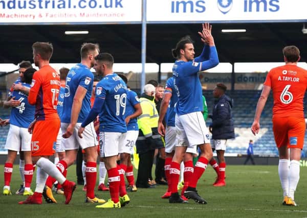 Christian Burgess toasts Pompey's victory against Northampton. Picture: Joe Pepler