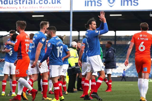 Christian Burgess toasts Pompey's victory against Northampton. Picture: Joe Pepler