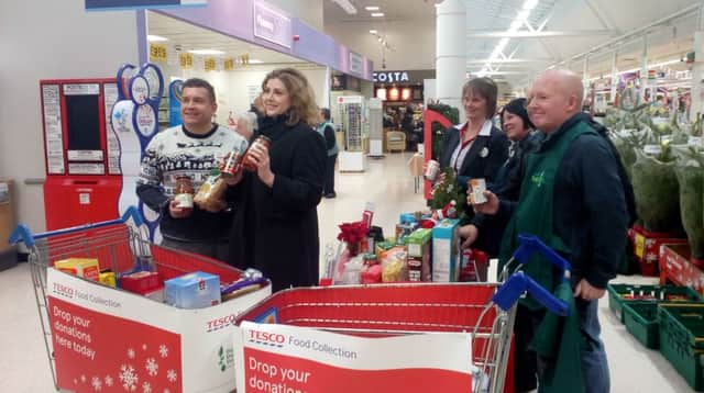Portsmouth North MP Penny Mordaunt, second from left, poses with Tesco staff and Portsmouth Foodbank volunteers. Picture: David George PPP-170212-122331001