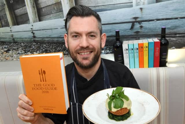 Head chef Mark Andrew with this year's Good Food Guide. Picture: Splendid Media Group