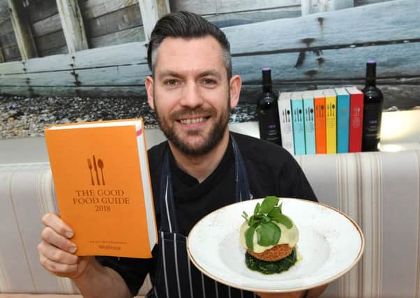 Head chef Mark Andrew with this year's Good Food Guide. Picture: Splendid Media Group