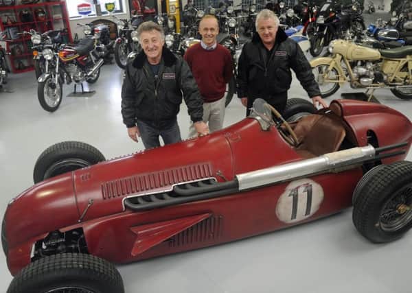 Martin Webb, right, and Ray Waller, left, of Comet Classics in Southbourne take possession of the Team Ant replica racing car from its builder Darren Collins, centre.
Picture: Ian Hargreaves