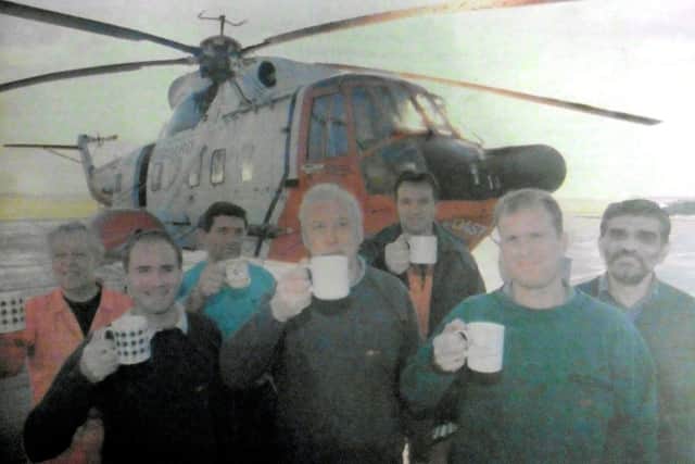 Captain Peter Nicholson, centre, leads his crew in celebration. From left, back row, Ken Glover, Terry Short, Mike McCutcheon and Jaffer Dharamsi. Front row, Nick Horst, Captain Nicholosn, and senior first officer Gary Queen