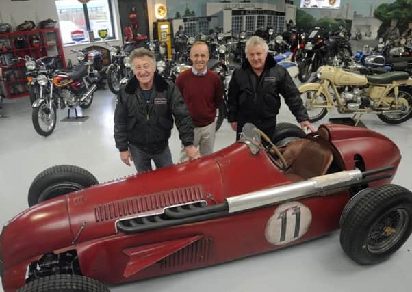 Martin Webb, right, and Ray Waller, left, of Comet Classics in Southbourne with the Team Ant racing car they bought at auction and Southbourne car enthusiast Darren Collins, who helped build it. Picture Ian Hargreaves (171671-1)