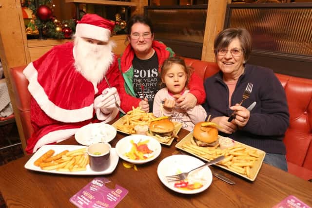 Father Christmas with Samantha Roberts and her daughter Chloe Blanford, four, and Sheila Blanford Picture: Habibur Rahman (171650-783)