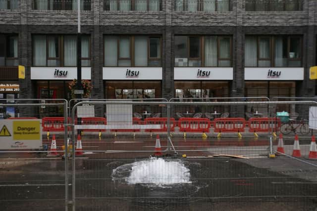 Water flows from a burst water main