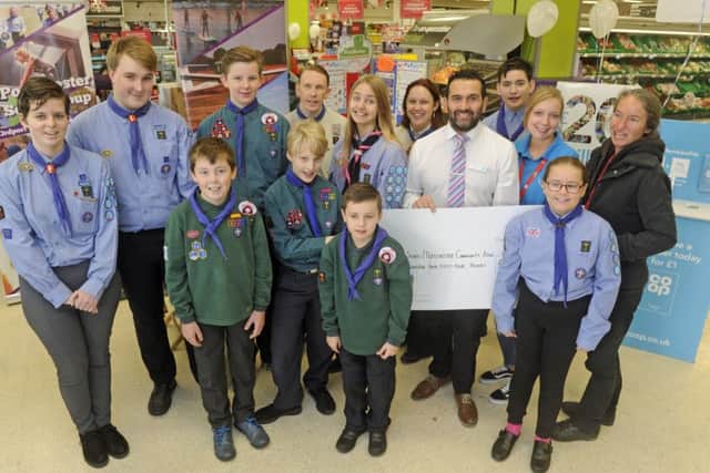 3rd Portchester Scouts and representatives of Portchester Community Association accept the cash from staff at the store.
Picture Ian Hargreaves