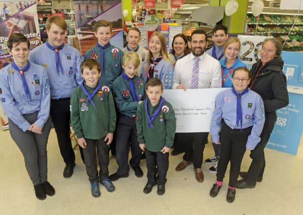 3rd Portchester Scouts and representatives of Portchester Community Association accept the cash from staff at the store.
Picture Ian Hargreaves