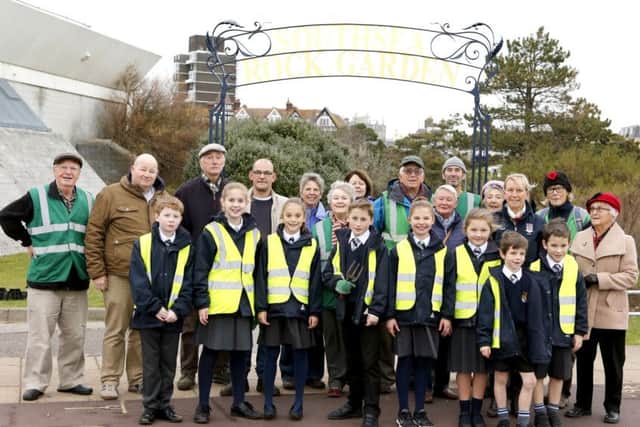 Friends of Southsea Rock Gardens with pupils from St Johns College and the makers of the ornate arch. Picture: Habibur Rahman