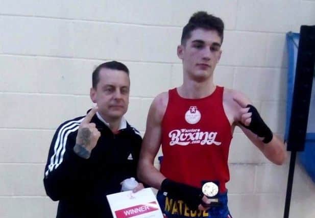 Gosport ABC's Mateusz Bereznicki celebrates with Tony Gaze, left, after winning the under-80kg title at the Endland Boxing Development Championship.