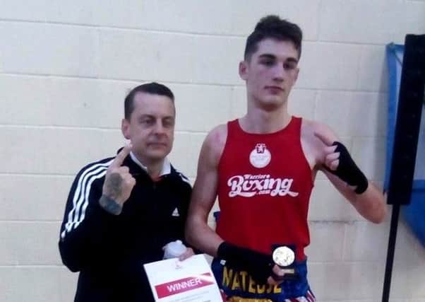 Gosport ABC's Mateusz Bereznicki celebrates with Tony Gaze, left, after winning the under-80kg title at the Endland Boxing Development Championship.