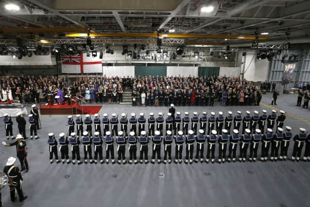 The Queen stands out in purple during a performance by the Royal Guard at the commissioning