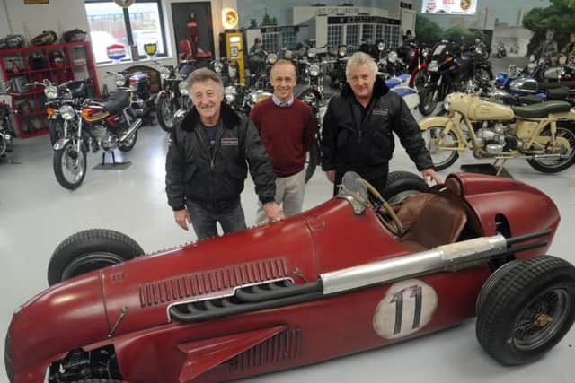 Martin Webb, right, and Ray Waller, left, of Comet Classics in Southbourne with the Team Ant racing car they bought at auction and Southbourne car enthusiast Darren Collins, who helped build it. Picture Ian Hargreaves (171671-1)