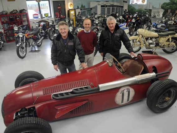 Martin Webb, right, and Ray Waller, left, of Comet Classics in Southbourne with the Team Ant racing car they bought at auction and Southbourne car enthusiast Darren Collins, who helped build it. Picture Ian Hargreaves (171671-1)