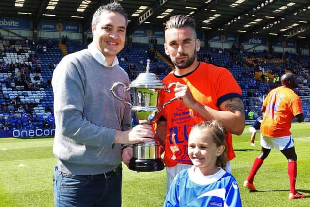 Steve Wilson hands over the 2013-14 player-of-the-season trophy to Ricky Holmes and his daughter Brooke Holmes