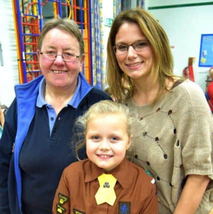 Liz Bartlett with Brownie Lilly-Anne Harvey, nine, in an old Brownie uniform, and her mother, Joanne Sims, who was a former Brownie invested into the troop by Liz
