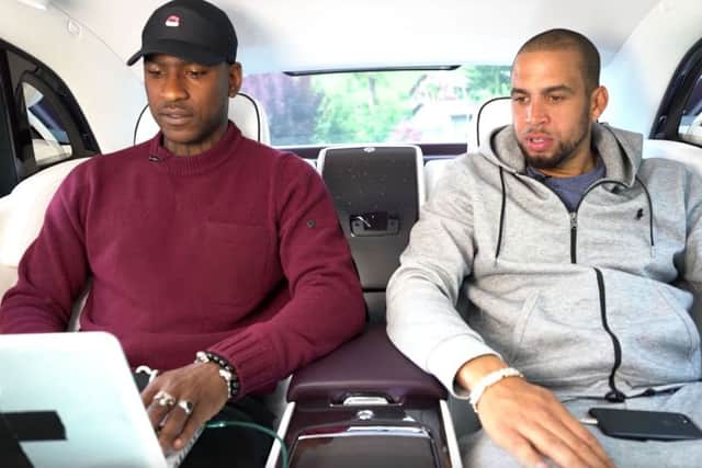 A screen grab from the Rolls-Royce Motor Cars YouTube channel of a promotional video showing grime artist Skepta, left, and a friend being driven in a car while not wearing a seatbelts