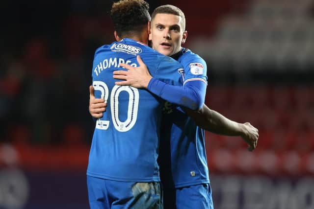 Stuart O'Keefe celebrates Pompey's win at The Valley with team-mate Nathan Thompson