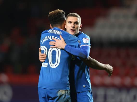 Stuart O'Keefe celebrates Pompey's win at The Valley with team-mate Nathan Thompson