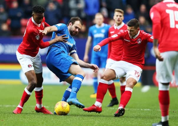 Brett Pitman is surrounded by a swarm of Charlton players. Picture: Joe Pepler