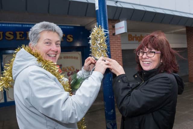 Catherine Sweatman and Ann Parker put up decorations
