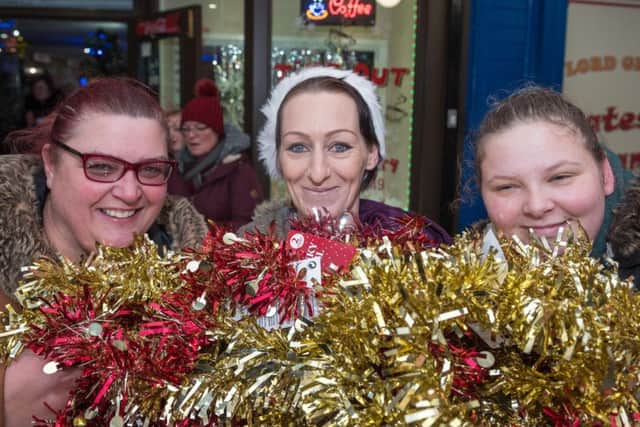Mandy Reeves, Hayley Charles and Samantha Bradbury with tinsel for the precinct Pictures: Vernon Nash