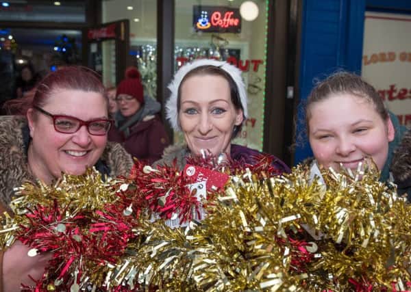 Mandy Reeves, Hayley Charles and Samantha Bradbury with tinsel for the precinct Pictures: Vernon Nash