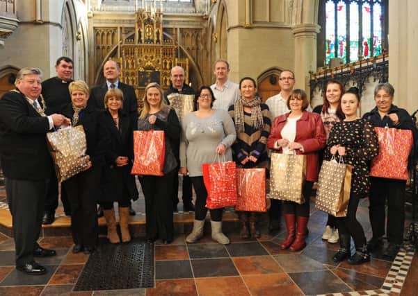 Back left, Father Bob White and, front left, then Lord Mayor of Portsmouth Cllr Frank Jonas with people from the groups that benefited from the voucher collectrion in 2012