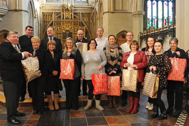 Back left, Father Bob White and, front left, then Lord Mayor of Portsmouth Cllr Frank Jonas with people from the groups that benefited from the voucher collectrion in 2012