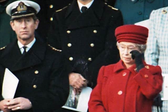 Her Majesty the Queen wiping away a tear pictured with the Prince Philip
