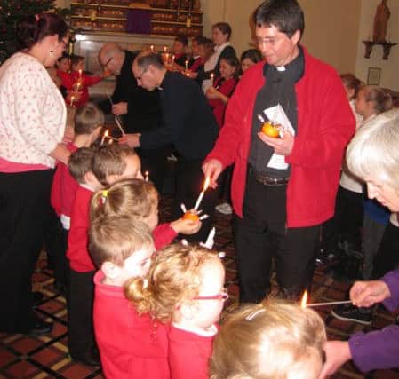 The Rev Andy Davis at a Christingle service