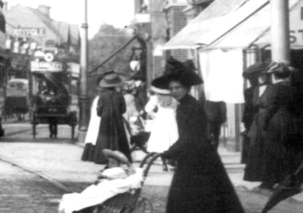In the previous photo it looks as though the girl in the white dress is walking on the pavement. But I think she is sitting on the pram handle.
(Barry Cox collection)