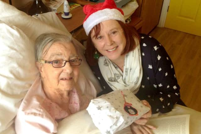 Debbie Cartmell from the QA delivers a gift to a resident at Bluewater Care Home as part of last year's appeal