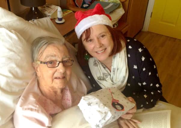Debbie Cartmell from the QA delivers a gift to a resident at Bluewater Care Home as part of last year's appeal